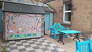 Courtyard Garden at Mackinnon House with a sign saying growing places
