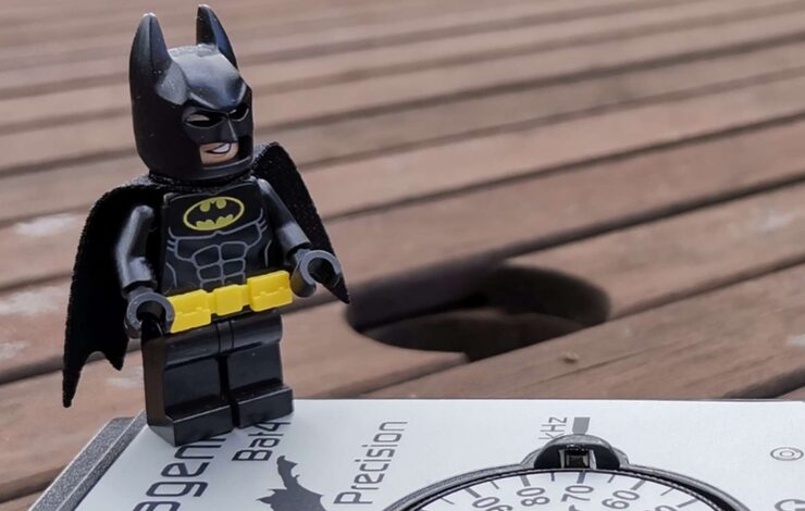 Lego batman standing on a compass