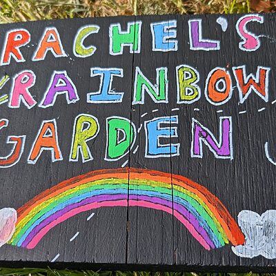 a sign for Rachel's Rainbow Garden