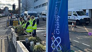 NHS Lothian staff planting containers at the entrance to the Royal Infirmary of Edinburgh