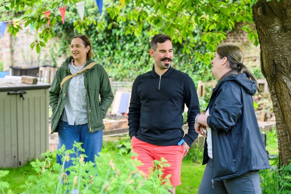 Three people outdoors attending a Branching Out event in Midlothian