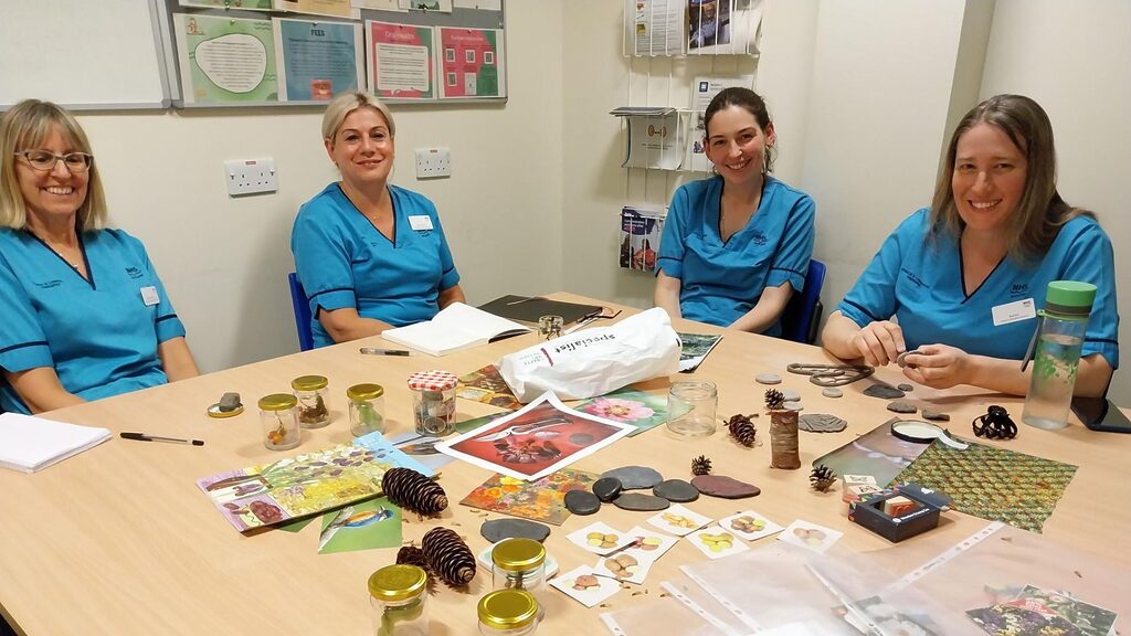 four NHS staff sitting round a table doing a nature-based activity