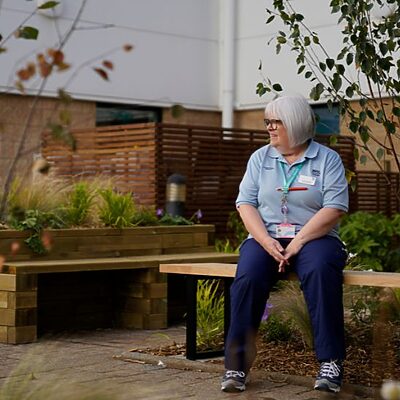 Staff member enjoying RIE wellbeing courtyard