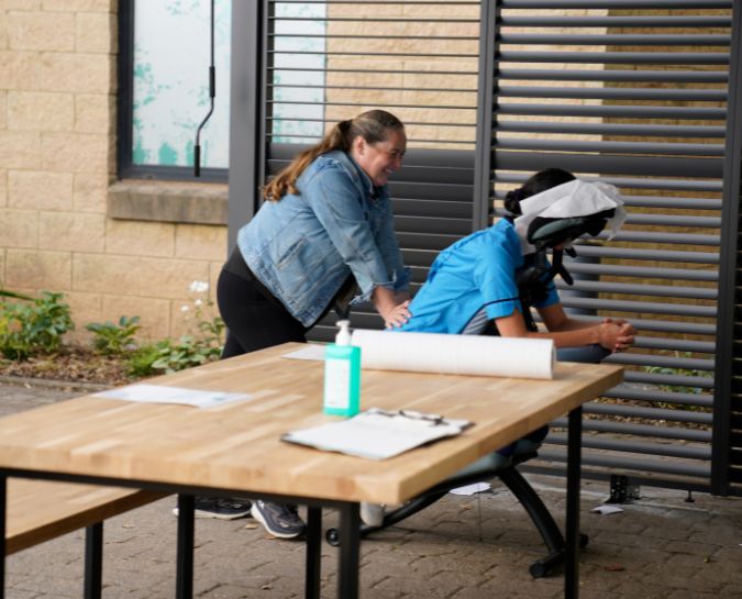Nurse getting massage in RIE Courtyard
