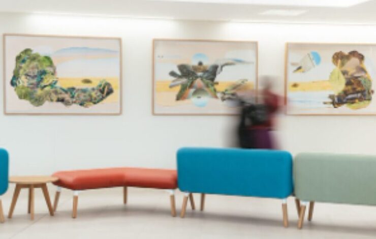 Artwork on walls with people walking past