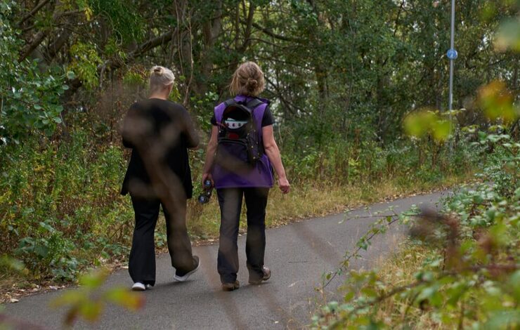 Lou walking with a staff member