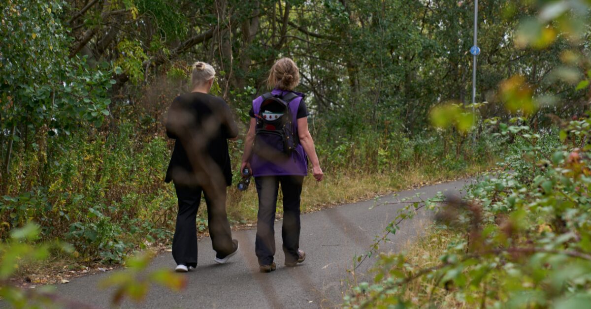 Lou walking with a staff member