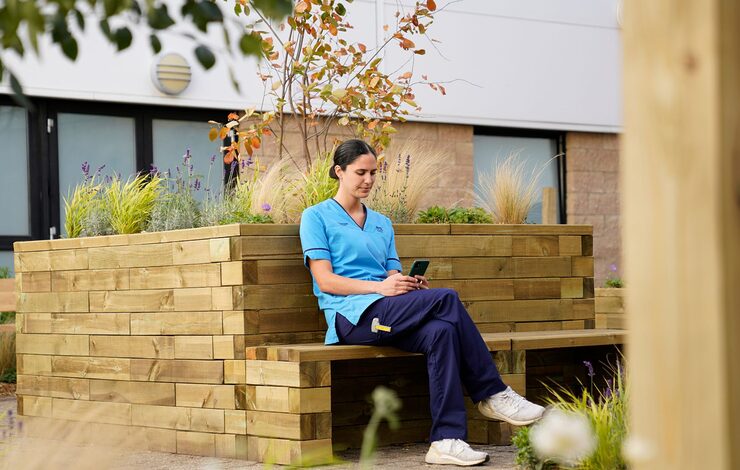 member of staff sitting in the staff wellbeing courtyard at the Royal Infirmary of Edinburgh