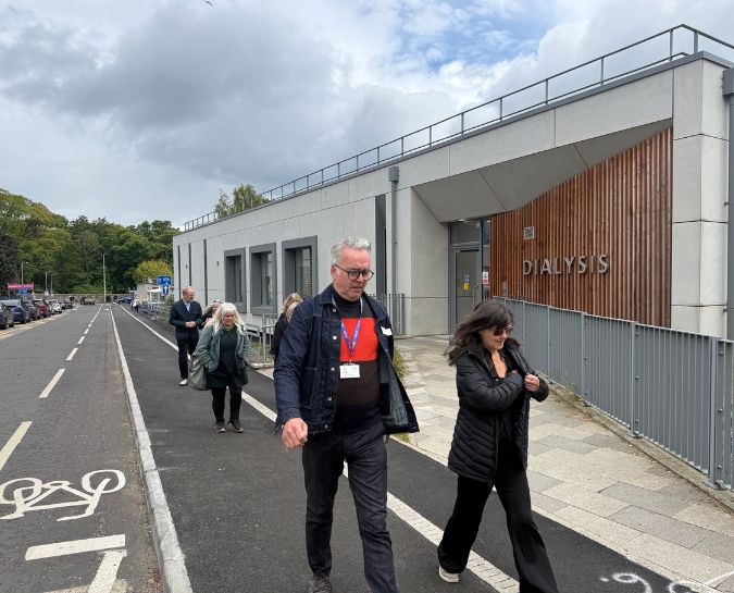 people walking outside of the kidney dialysis unit