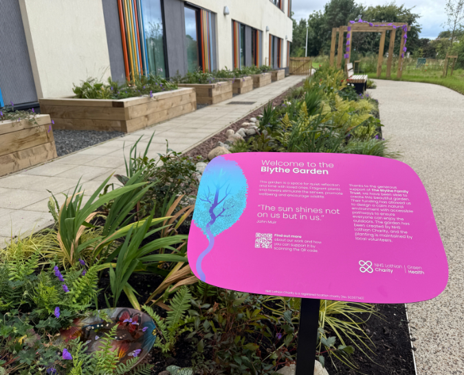 Garden with sign saying 'Welcome to the Blythe Garden'